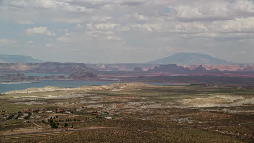 Aerial view of Lake Powell in Glen Canyon National Recreation Area showcasing the breathtaking desert landscape with partly cloudy skies in Utah and Arizona
