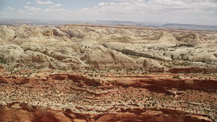 Aerial footage of the breathtaking rock formations at Capitol Reef National Park in Utah during a sunny summer day