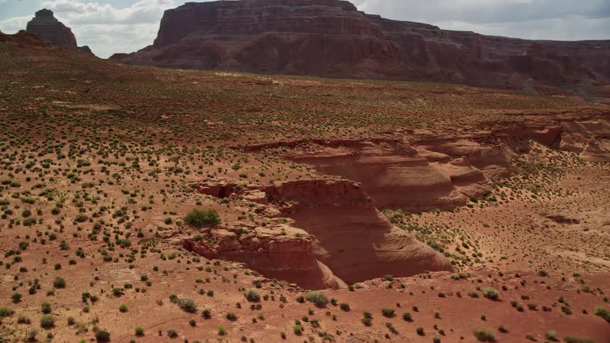  aerial footage capturing the majestic mesa cliffs desert vegetation and native American tribal lands on the Navajo Nation Reservation in Arizona during a sunny day in summer