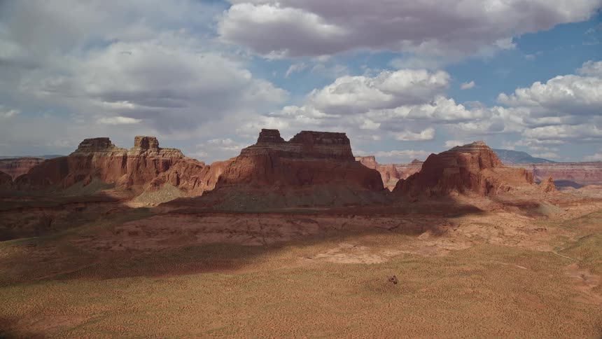  aerial footage of approaching large buttes in Navajo Nation Reservation Arizona showcasing the arid tribal landscape of the Southwest United States during summer