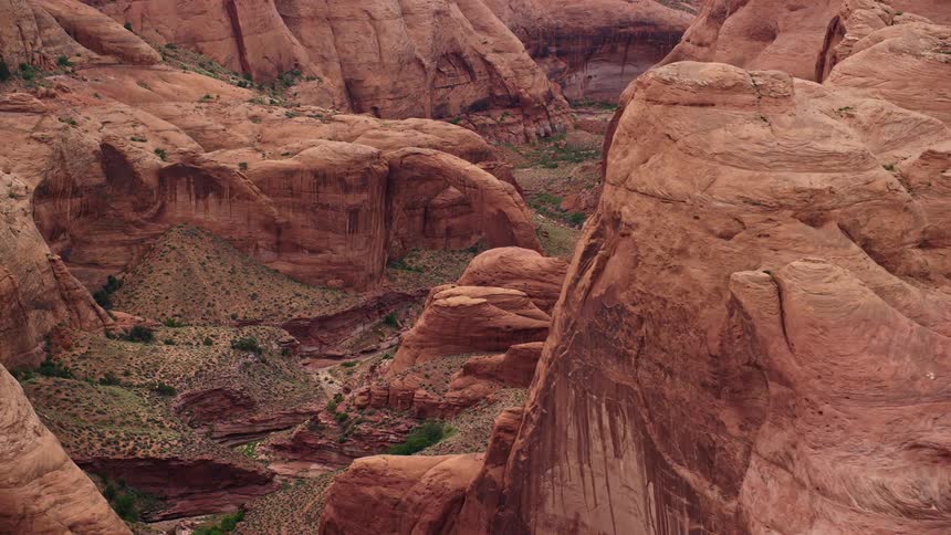 A stunning aerial view of a rock formation and stone arch in Rainbow Bridge National Monument Utah captured during a flyby inresolution