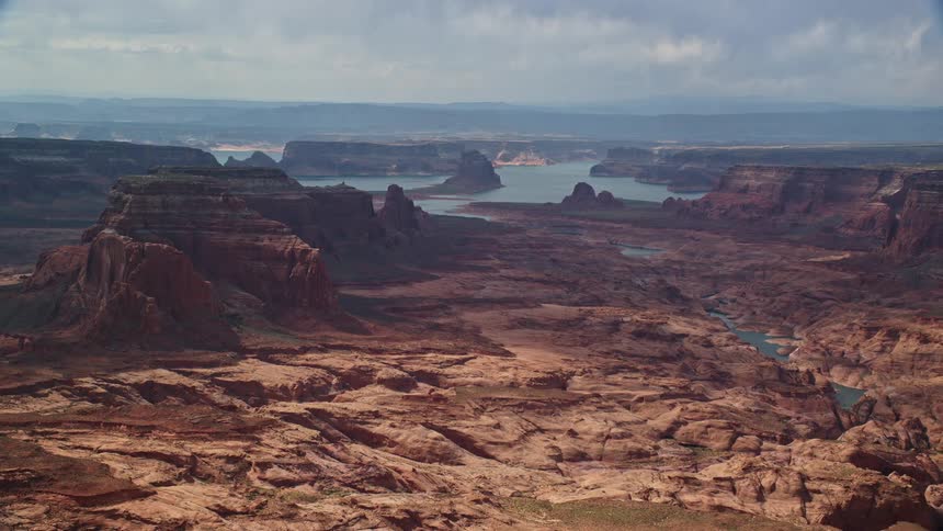  aerial footage showcasing the picturesque landscape of buttes with Lake Powell in the background situated on the Navajo Nation Reservation in Arizona during the summer