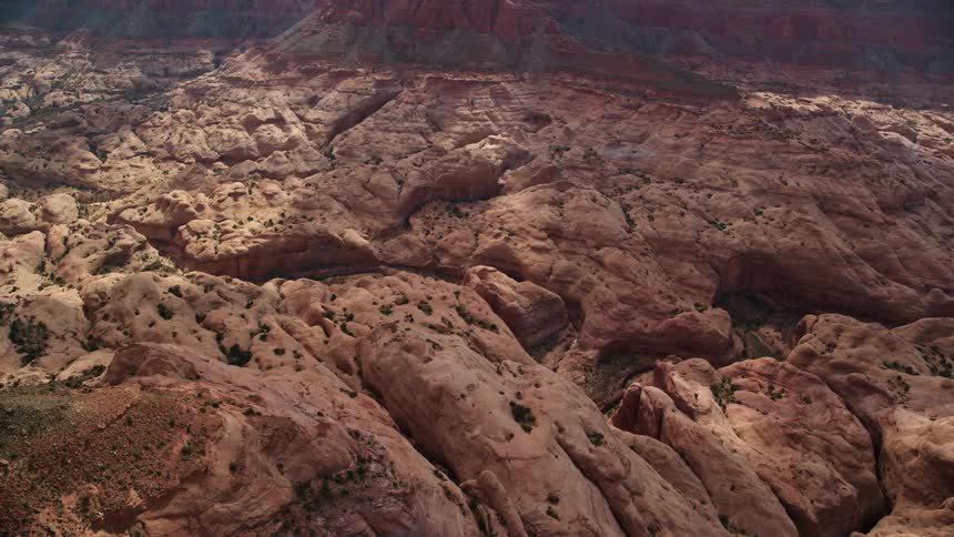 Flying over the Navajo Nation Reservation in Utah thisaerial video captures the breathtaking views of narrow canyons winding through the arid desert landscape