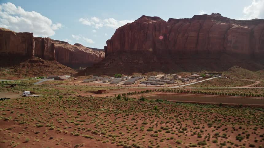 Aerial footage capturing the stunning landscape of Goulding's Lodge in Goulding Utah showcasing the beauty of the Southwest United States during a partly cloudy summer day