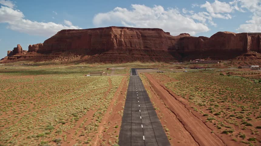 Approaching Monument Valley Airport in Utah thisaerial footage showcases the arid landscape famous table mountains and the historical Navajo Nation Reservation from a low altitude as the aircraft makes its approach to the small airfield