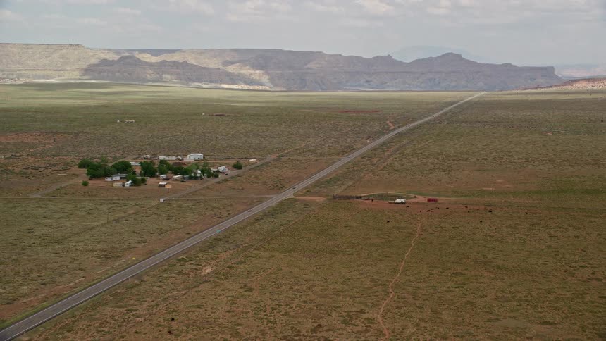 Aerial footage of Highway 89 with buildings and mountains in the background taken in Glen Canyon National Recreation Area Utah Arizona