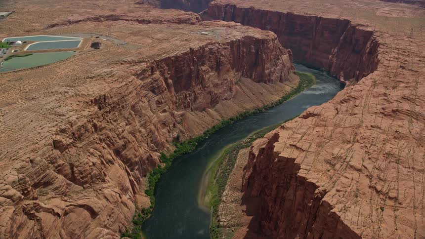  aerial footage of flying over Glen Canyon Arizona capturing the stunning beauty of the canyon Colorado River and water passages during the day in the Southwest United States