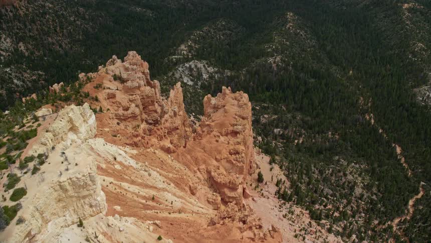 Tilt down from a bird's eye view of pink cliffs and rock formations in Bryce Canyon National Park Utah