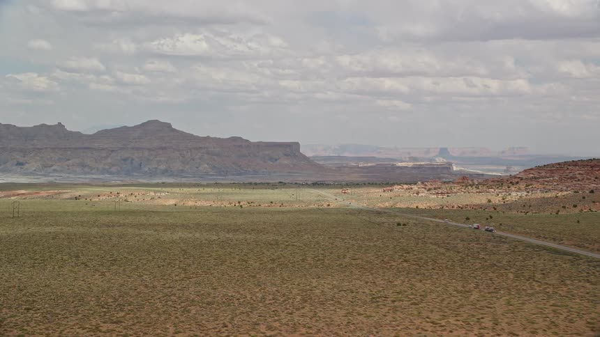 Aerial footage reveals a scenic view of Highway 89 as it winds through a rustic small town in the Glen Canyon National Recreation Area showcasing the arid desert landscape of Utah and Arizona