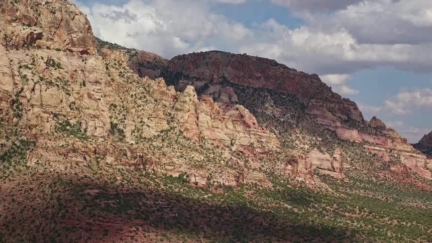 Aerial footage of Navajo Mountain in Utah showcasing rocky slopes and an mountain peak in the Southwest United States during summer