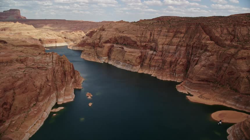Aerial view of Lake Powell canyons in Navajo Canyon Arizona during a partly cloudy day in Utah