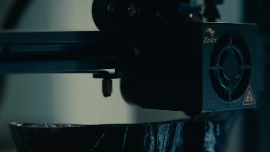 A 3d printer printing something that is black