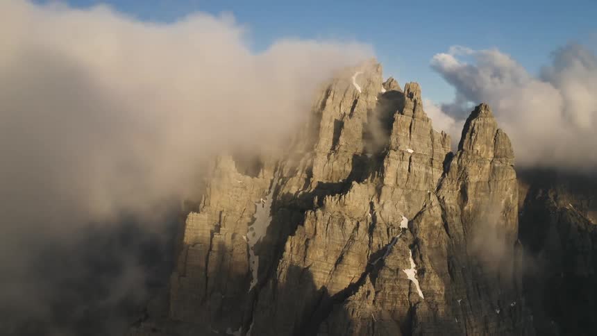 The clouds cover the top of the mountain