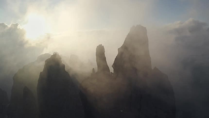 Aerial view of clouds covering the mountains is displayed