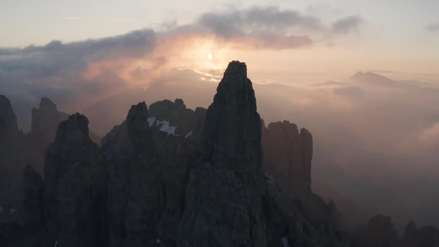 The jagged summit of a barren stone mountain in the evening