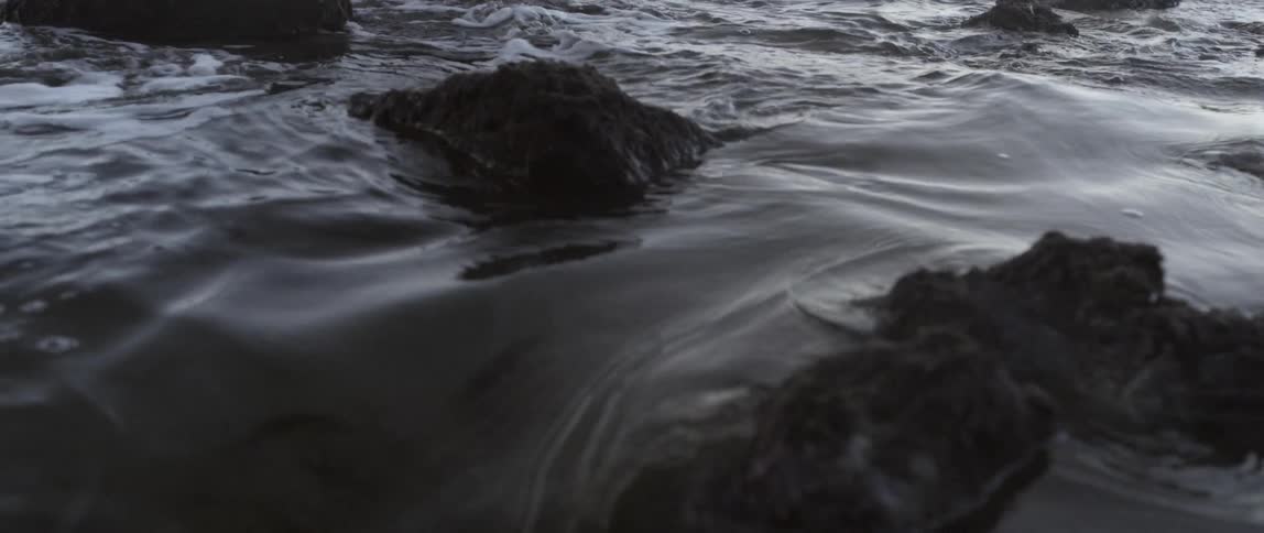 Water moves past these rocks splashing around