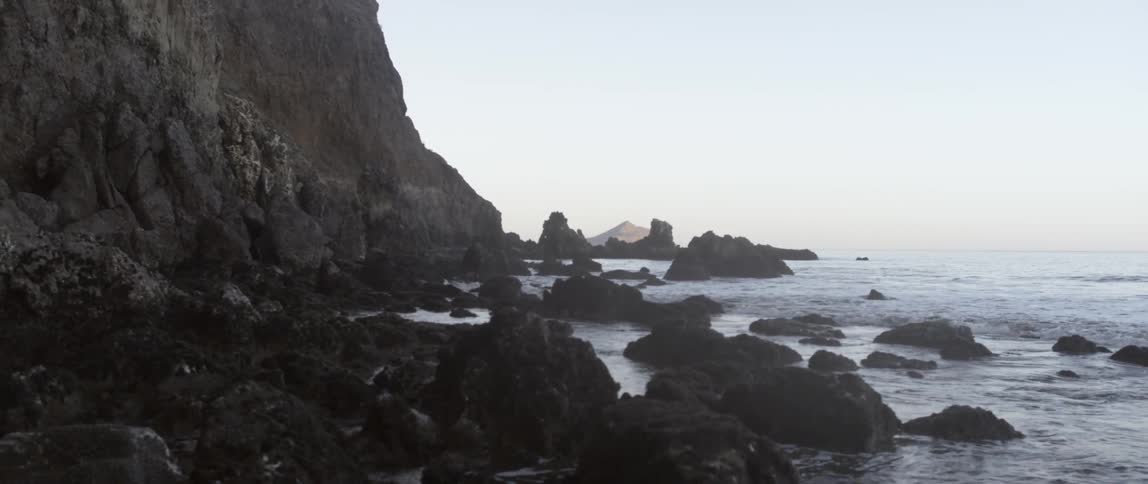 Waves crash against the rocky shore