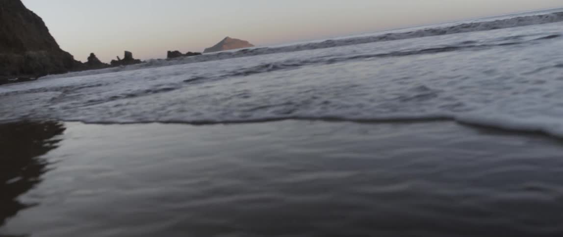 The waves are slowly moving on the beach