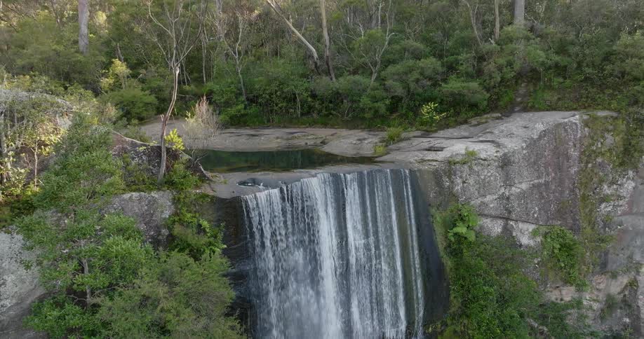 A waterfall goes over a tall cliff