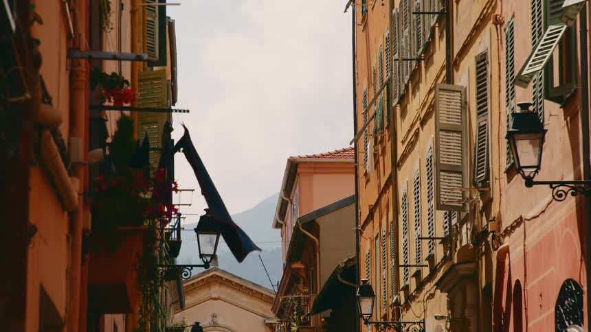 View of a suburban area with old buildings and wooden windows and in the horizon a mountain range
