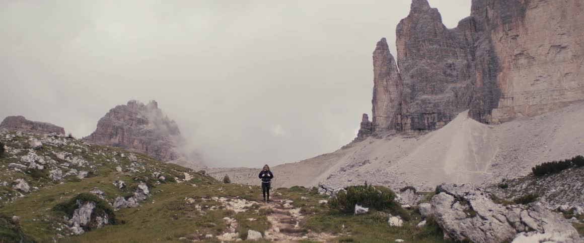 Woman hiking amidst the mountains in winter