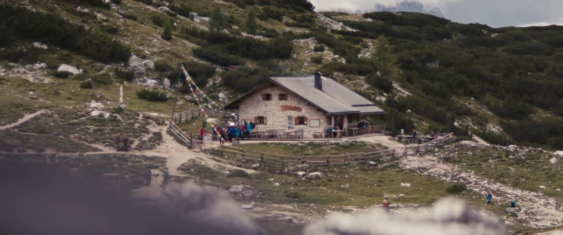 A group of people gathered in a wooden house on the mountain