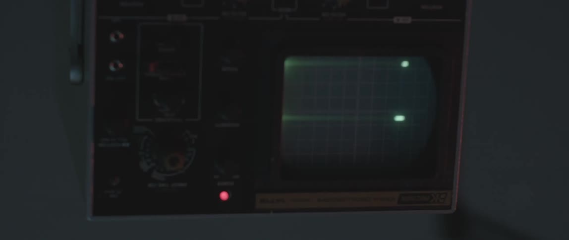 A monitor has small green lines moving on it