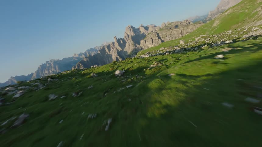 FPV Drone High Speed close Proximity Aerial of a rocky mountain during a sunny day