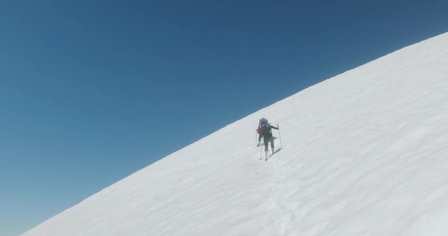 Hikers trek up the snowy mountain