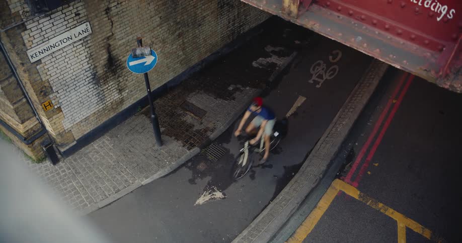 Cyclists pass under railway bridge in London