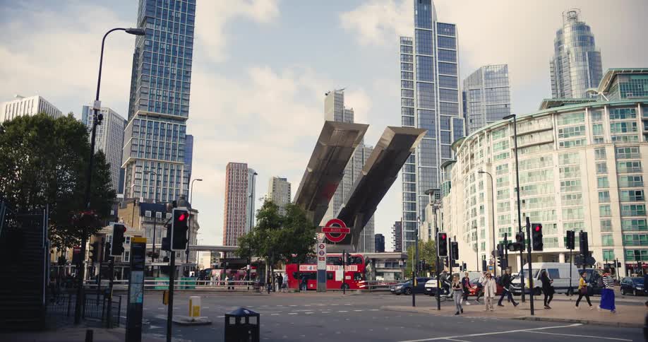 People and vehicles at Vauxhall Underground Station with the cityscape behind