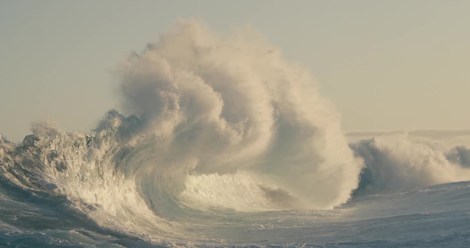 A large wave crashes in the ocean