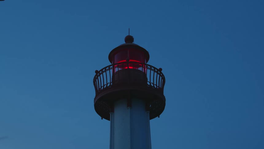 Tower with a central red blinking light during twilight