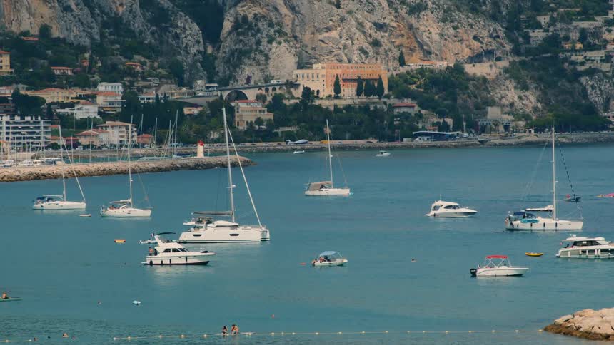 View of yachts parked in the sea in a small seaside town