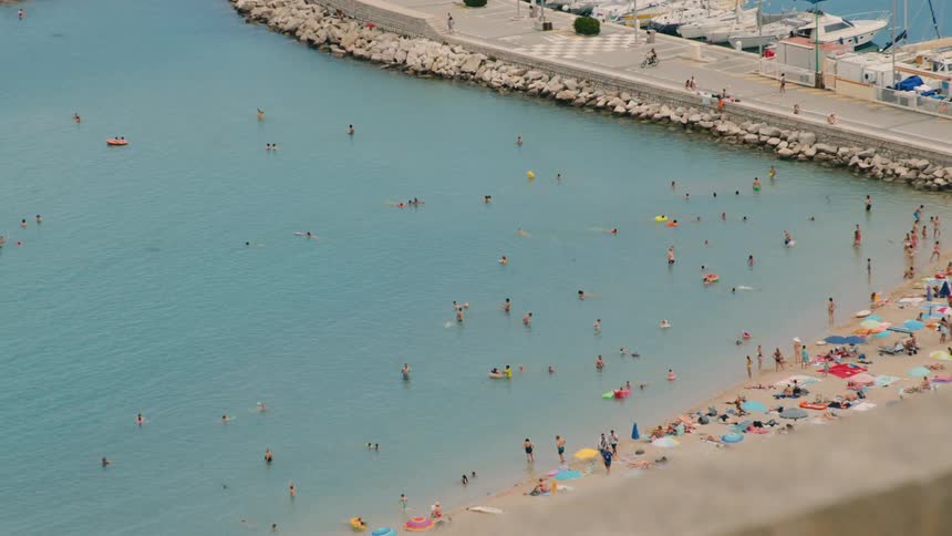 People having fun on the beach on a hot summer day