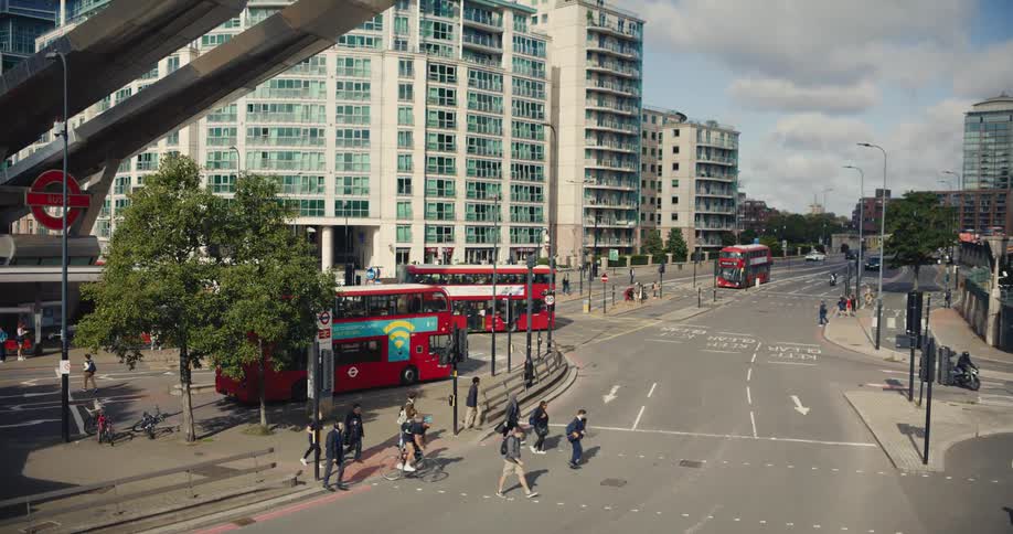 Pedestrians crossing road by Vauxhall train, bus and underground station