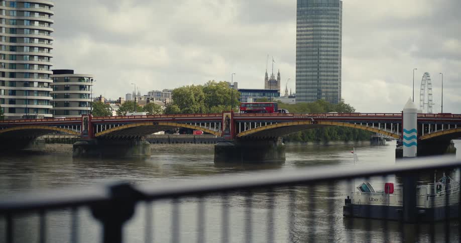 Traffic moving over Vauxhall Bridge with the London Eye visible behind