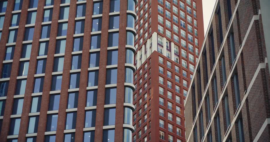 Tall apartment and office buildings clad with brick in London