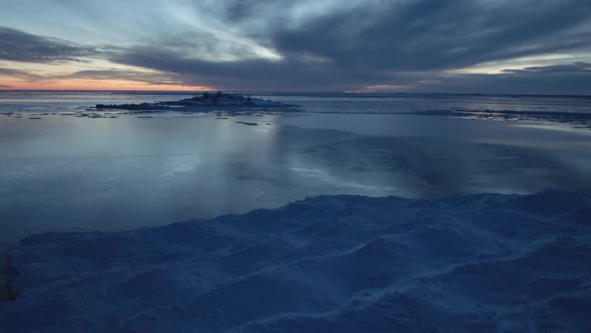 The tide flows lightly towards the shore