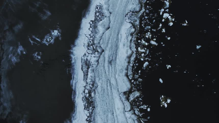 Chunks of ice from an iceberg floating in the sea