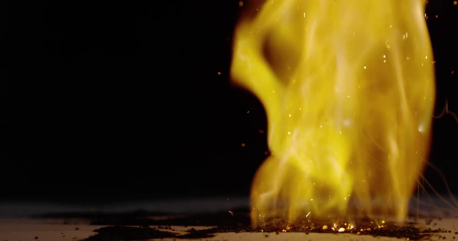 The fire sparks and burns the paper