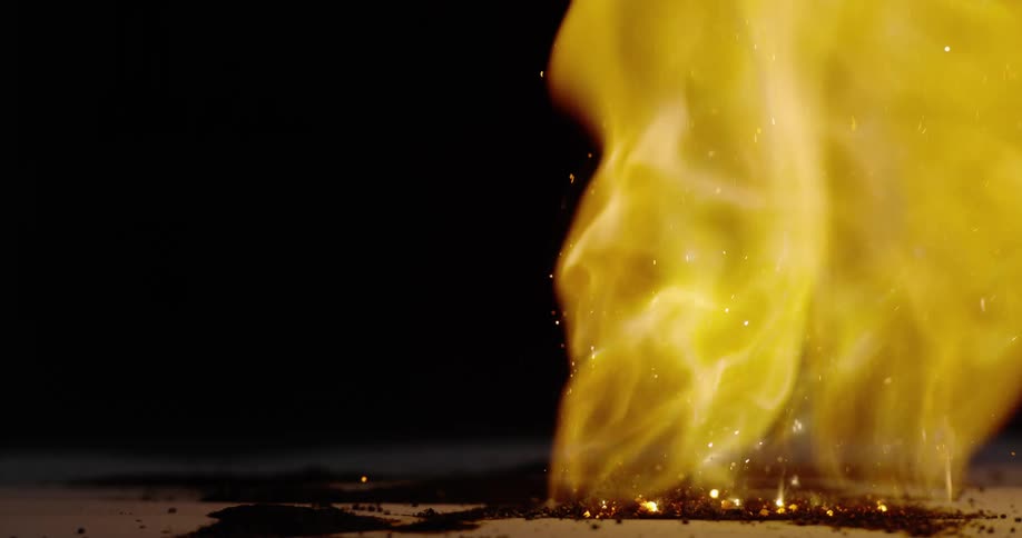 Sparks fly from a fire as flames grow taller