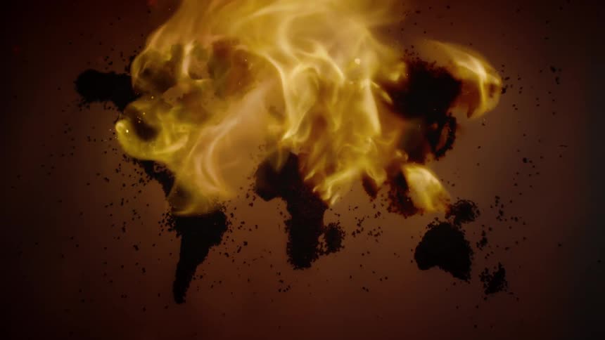 Flames burn on the surface over a rough map of the world