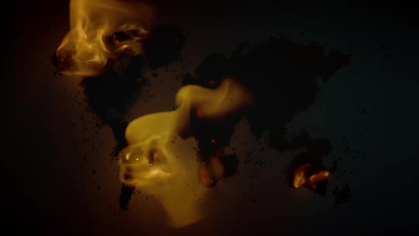 A fire burns on a map of the world