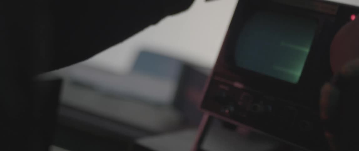 Person adjusting a piece of electronic equipment