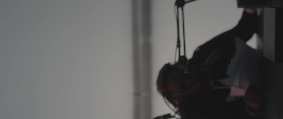 Dj performing as the camera moves away from him while it's spinning