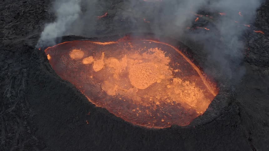Aerial view of a volcano spewing lava during an eruption