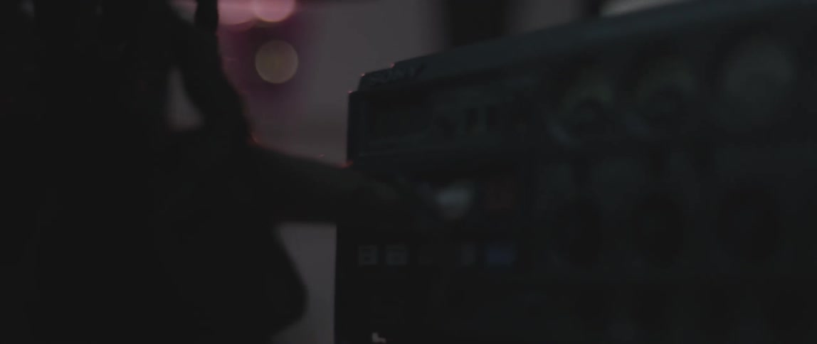 A person is using a machine in a dark area