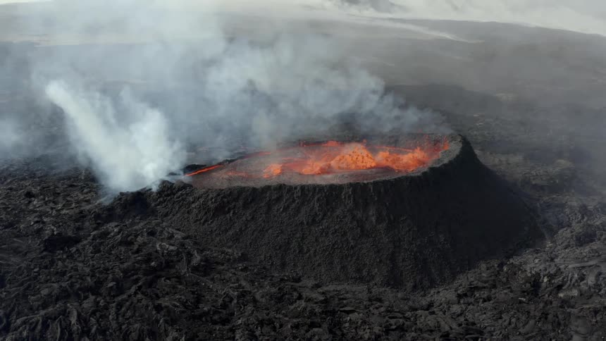 Aerial view of an active volcano with bubbling lava