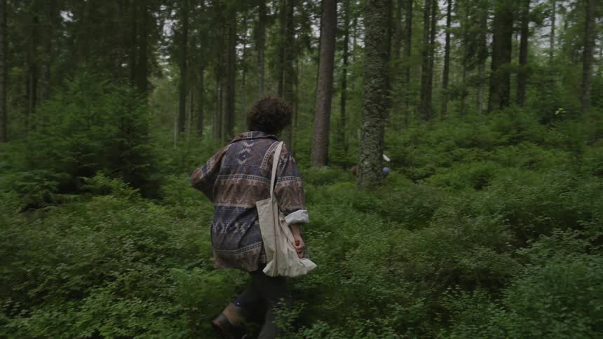 A woman running through a forest